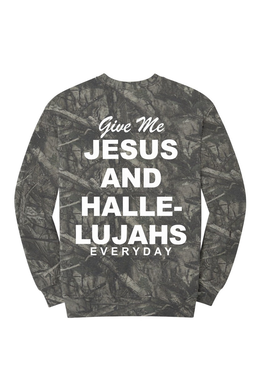 A long-sleeve crewneck sweatshirt featuring a dark gray and black woodland camouflage pattern with bold white text on the front that reads &