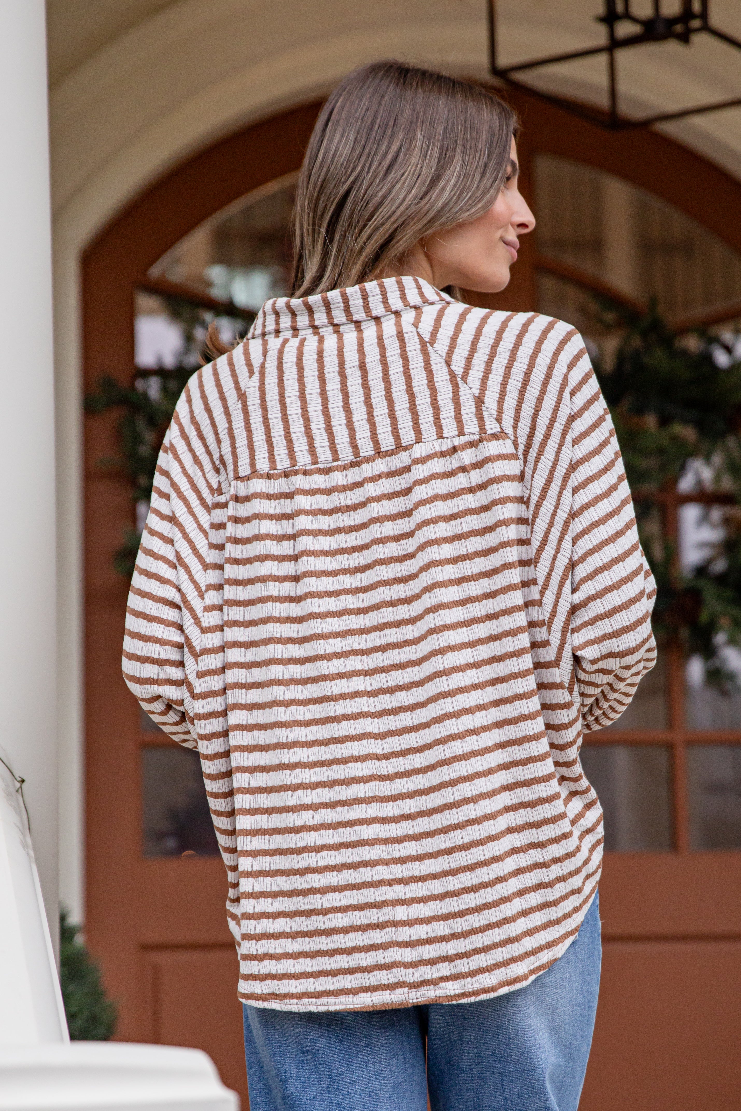 Woman wearing a striped shirt with a blurred background
