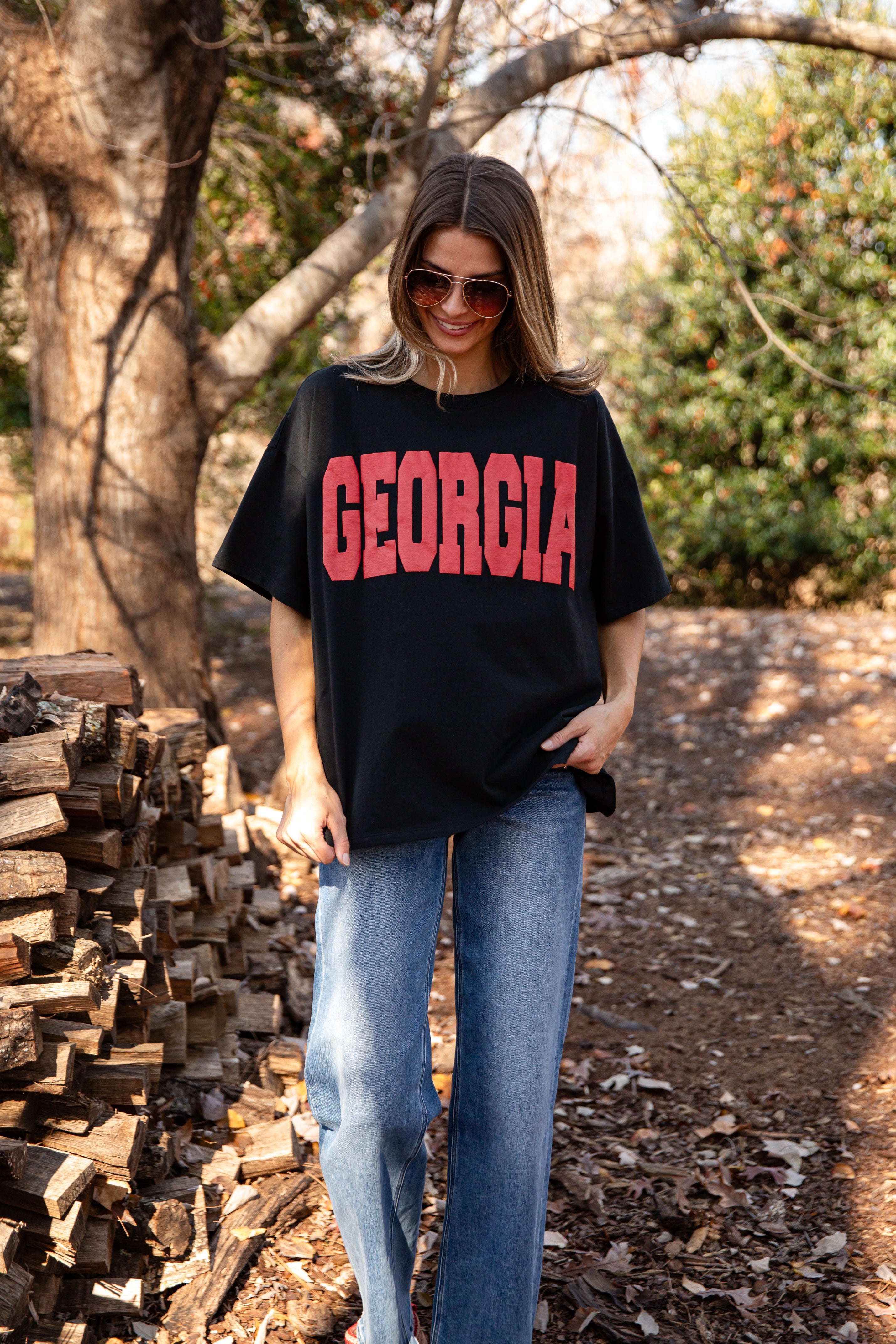 Woman wearing a black t-shirt with &