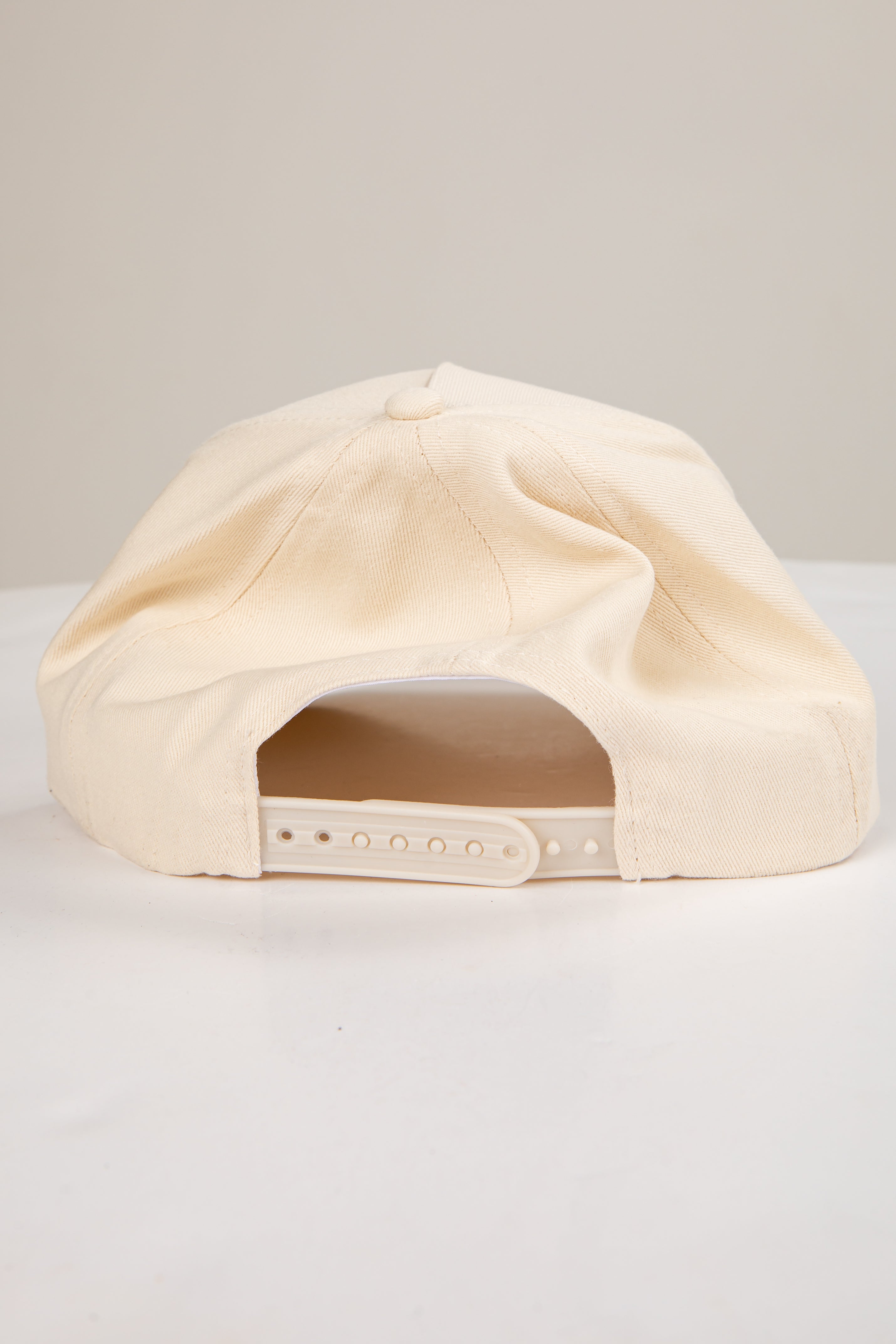 Beige cap on a light gray background