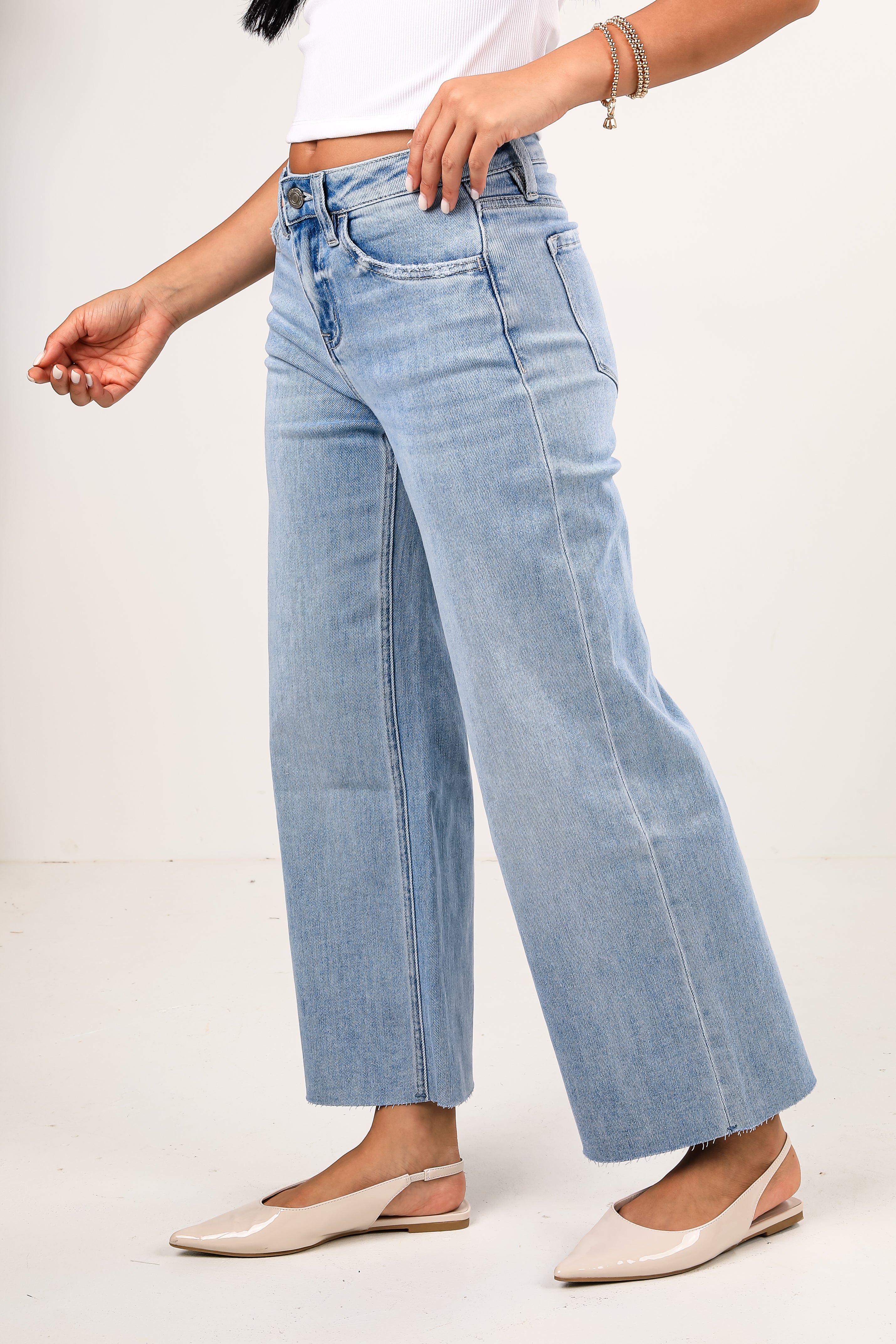Light blue jeans worn by a person on a white background