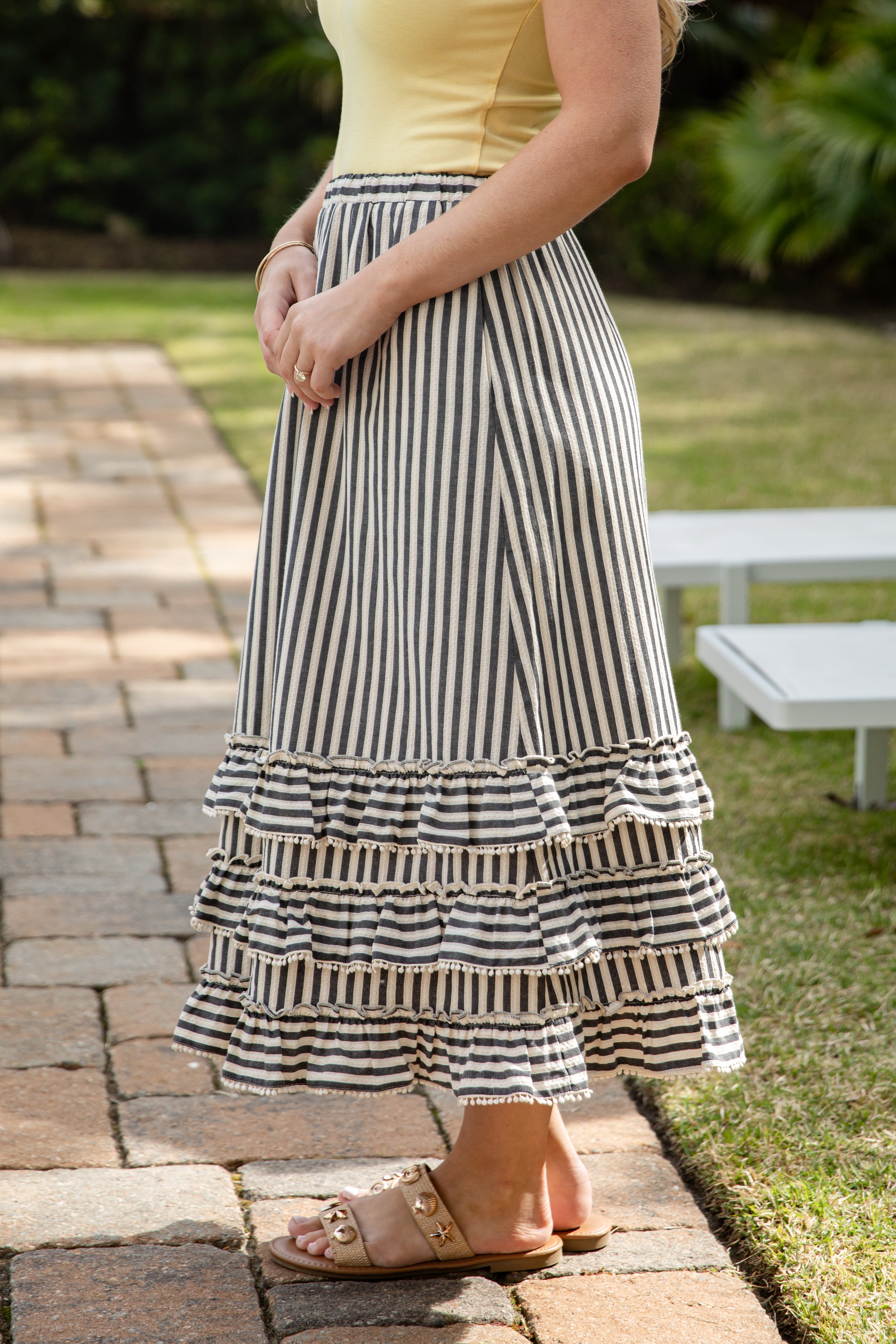 Woman wearing striped maxi skirt.