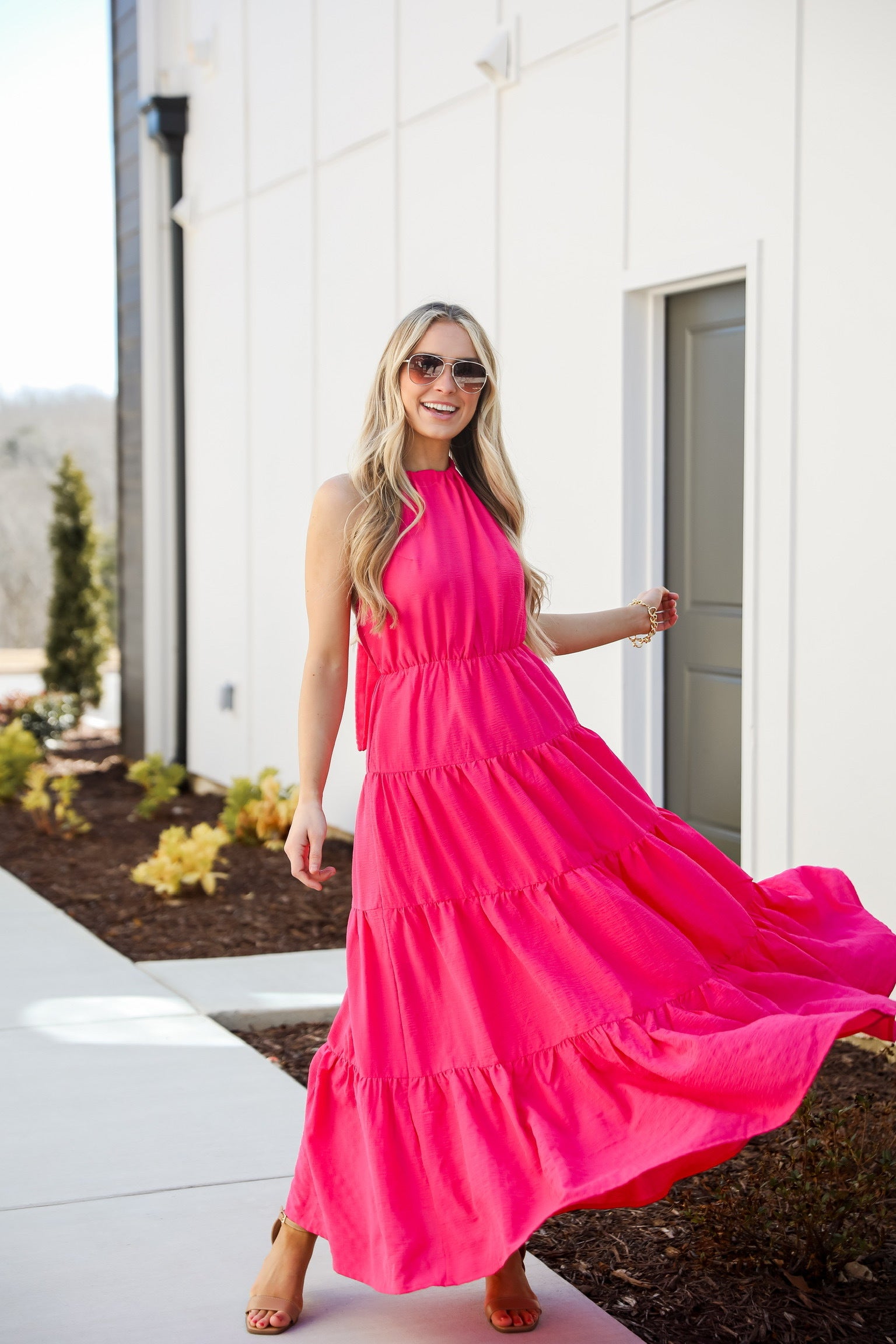 Harvey Boutique model in a pink maxi dress