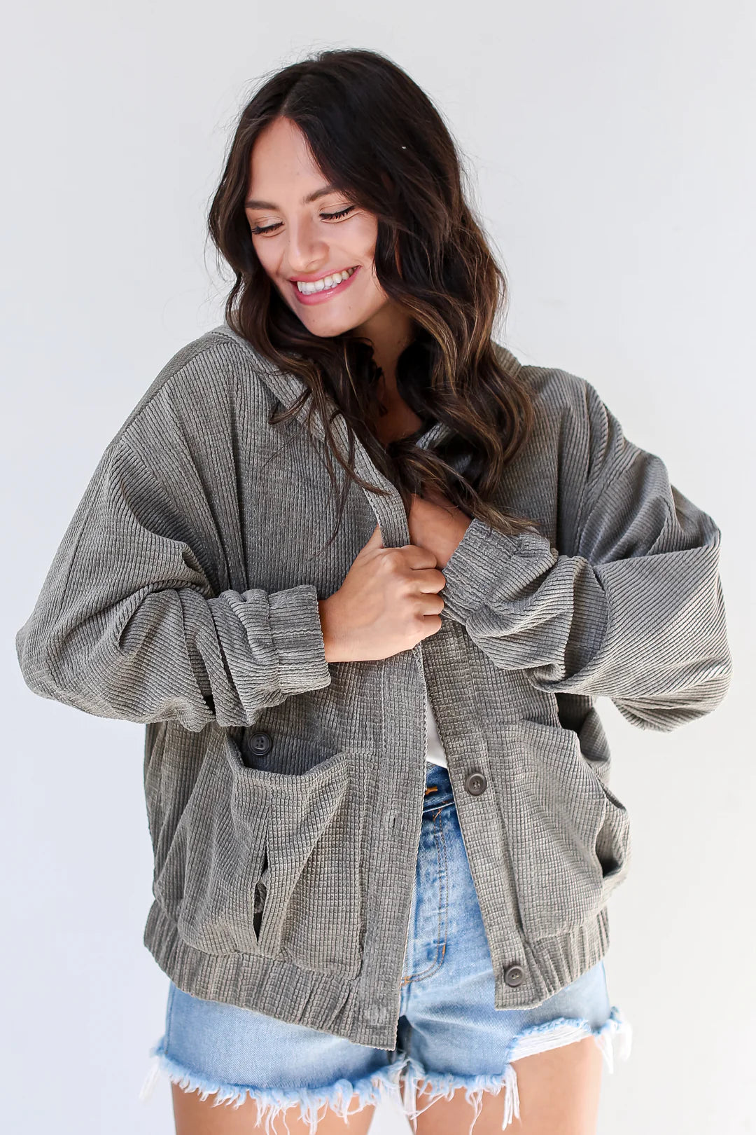 Harvey Boutique model in olive oversized jacket and jean shorts