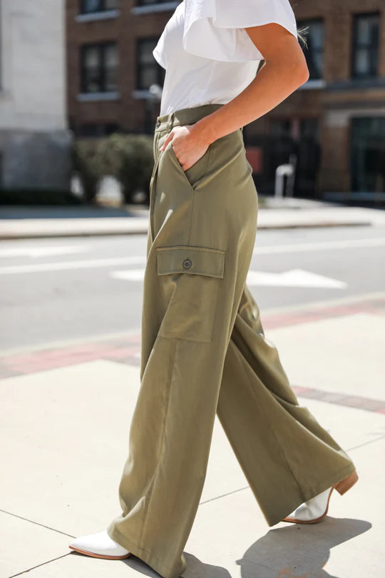 Image of Harvey Boutique model wearing white shirt and green cargo pants