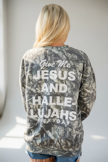 A woman viewed from behind wearing a gray and black camouflage sweatshirt with bold white text on the back that reads, &
