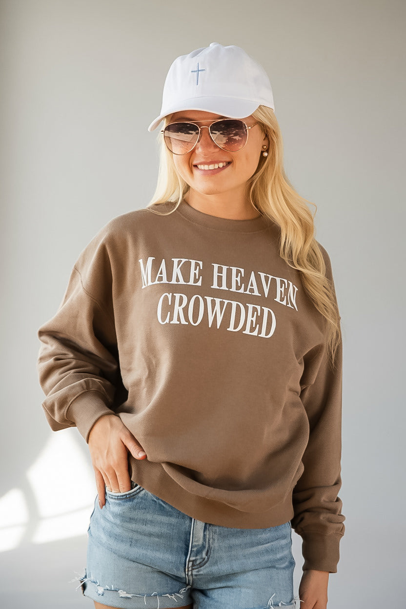 A woman wearing a brown crewneck sweatshirt with &