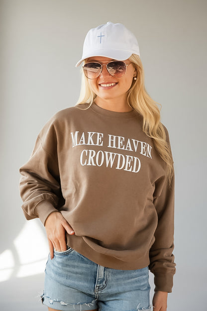 A woman wearing a brown crewneck sweatshirt with &