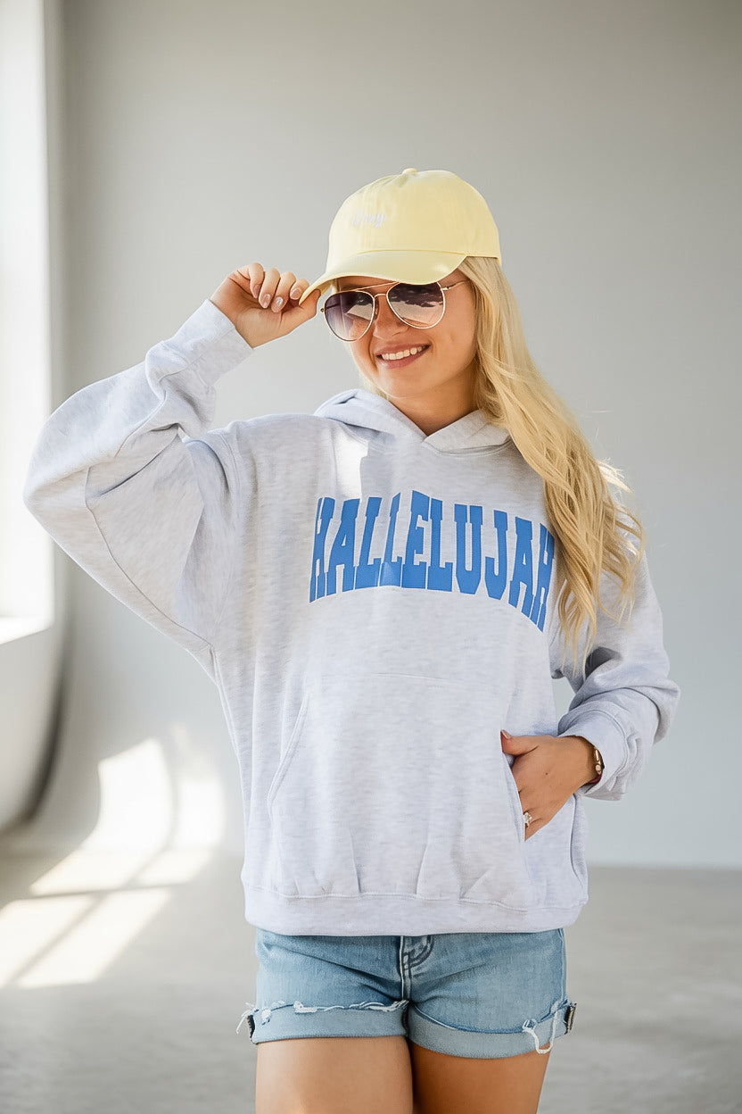A woman wearing a light heather gray hoodie with &