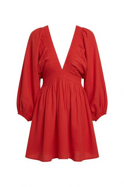 A red long-sleeve mini dress with a smocked bodice, gathered ruffles, and a flared skirt, shown against a plain white background.