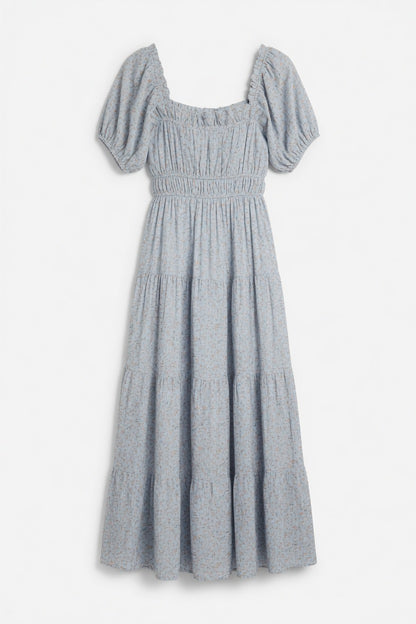 A light blue smocked dress with puff sleeves, a square neckline, and a tiered skirt, shown against a plain white background.