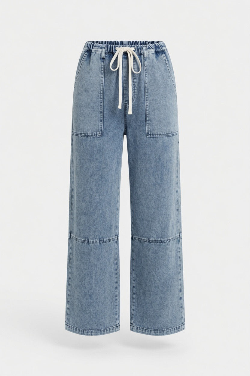 Light blue wide-leg denim pants with a drawstring waist and front patch pockets, shown on a plain light gray background.