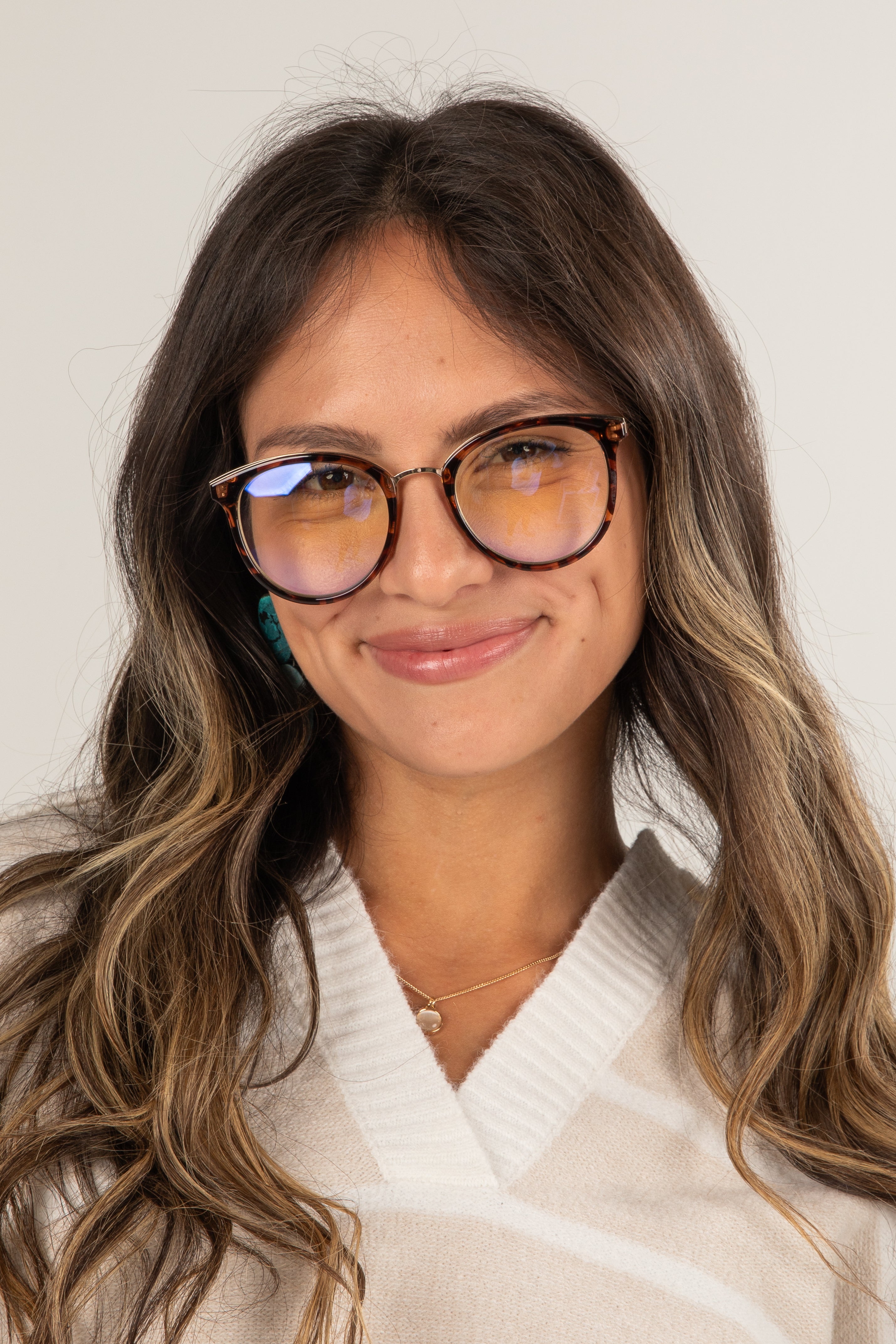 Woman wearing glasses with a neutral background
