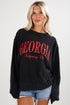 Woman wearing a black sweatshirt with &