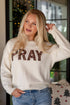 Woman wearing a white sweater with &
