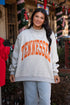 Person wearing a gray sweatshirt with &