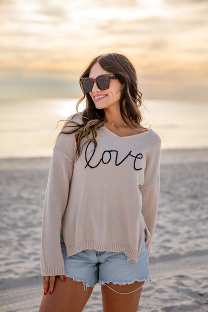 Woman wearing a sweater with &