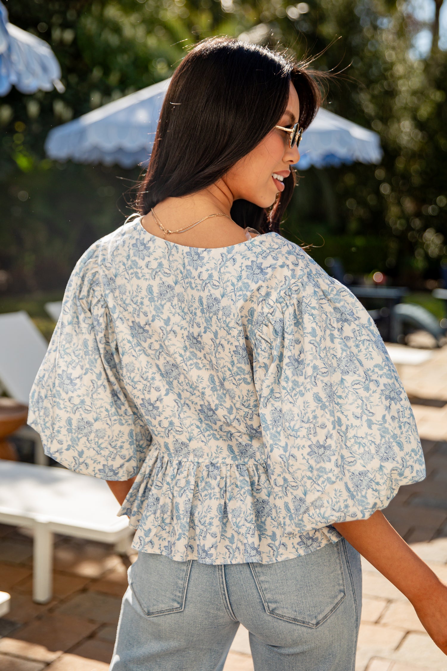Woman wearing a floral blouse in an outdoor setting