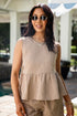 Woman wearing a checkered dress and sunglasses outdoors