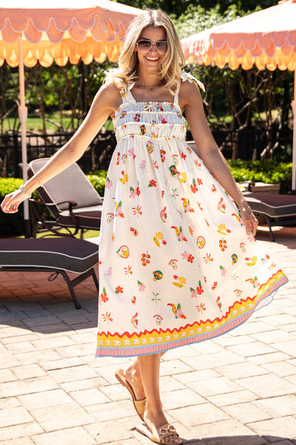 Woman in a colorful dress standing outdoors under patio umbrellas.