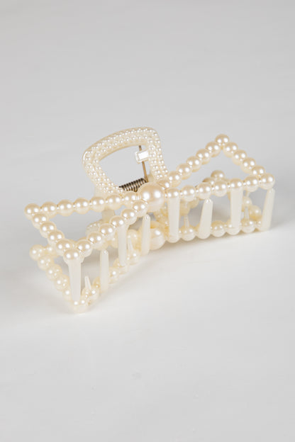 Pearl hair clip on a light gray background