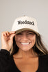 Person wearing a white cap with &