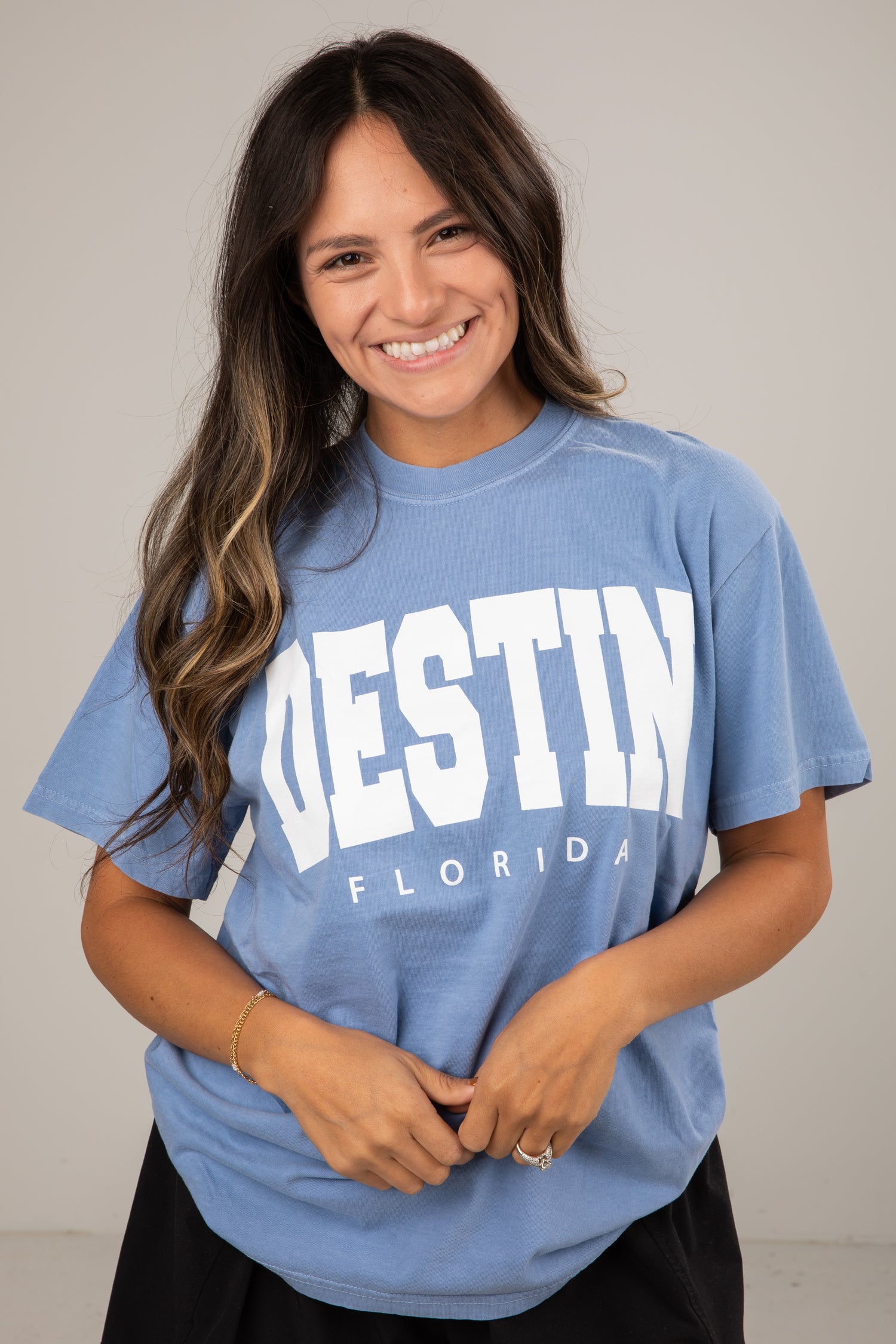 Woman wearing a blue t-shirt with &