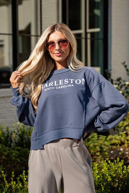 Woman wearing a blue sweatshirt with &