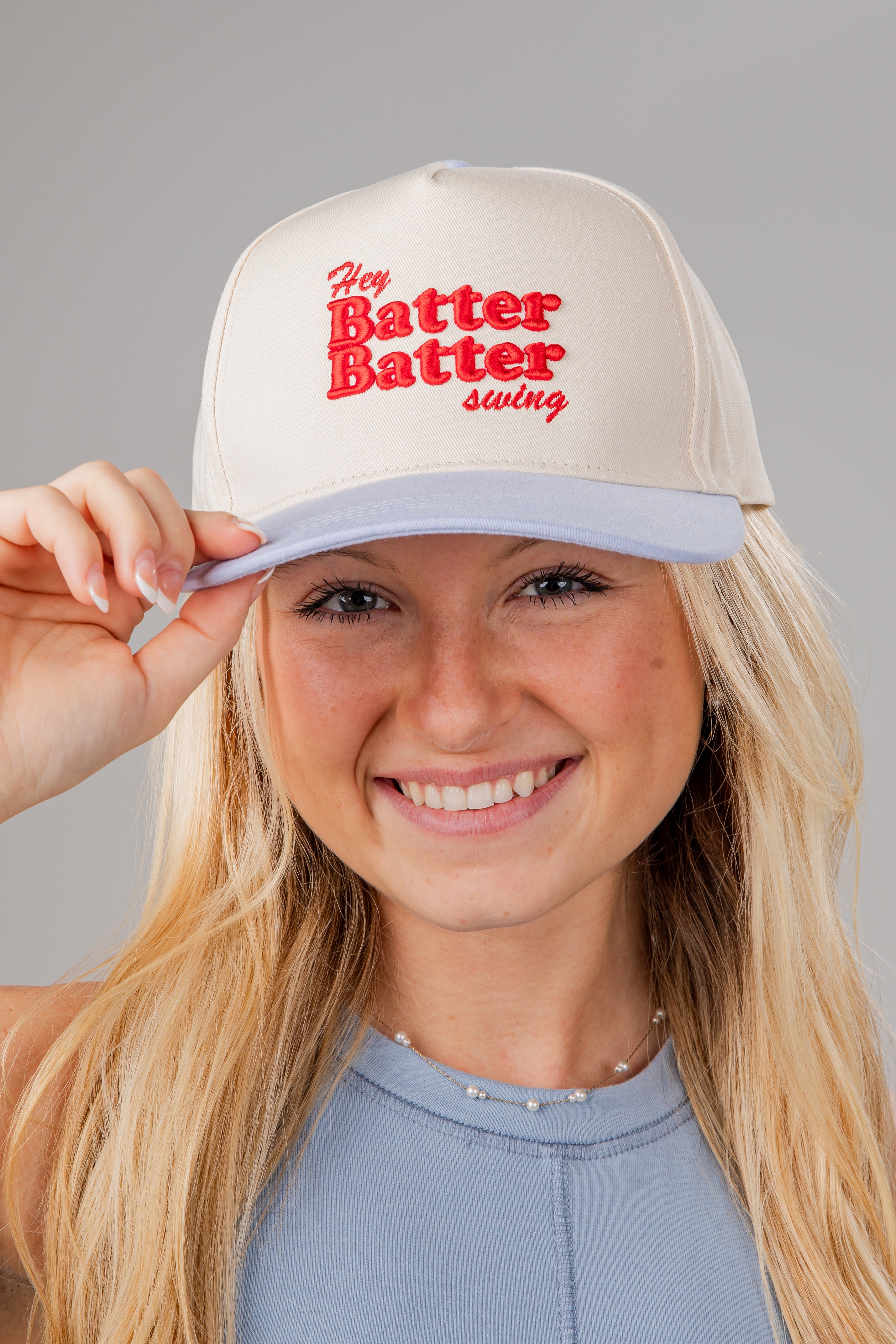 Person wearing a cap with &