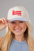 Person wearing a cap with &