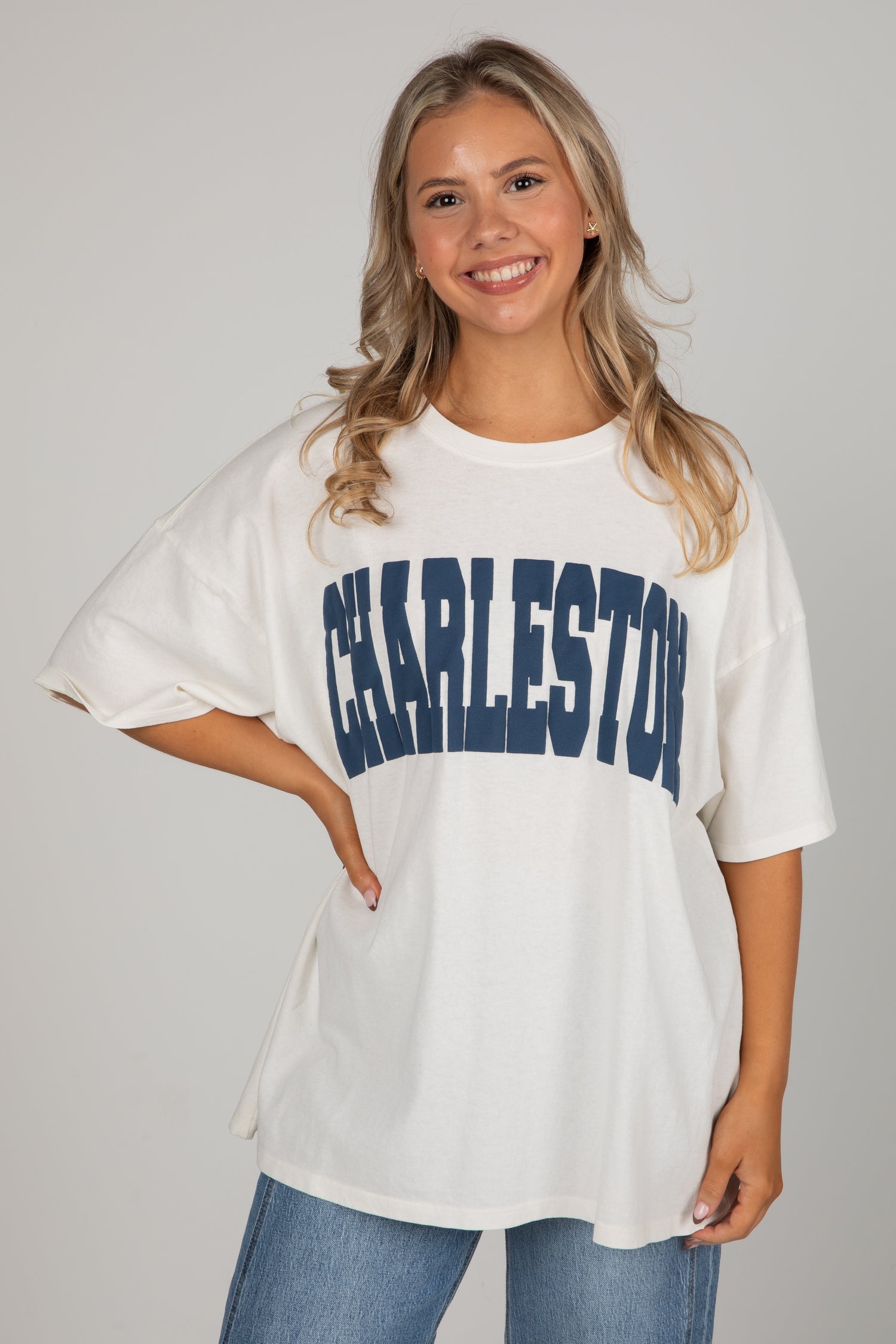 Woman wearing a white oversized t-shirt with &