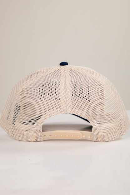 Beige mesh cap with a small logo on a light gray background