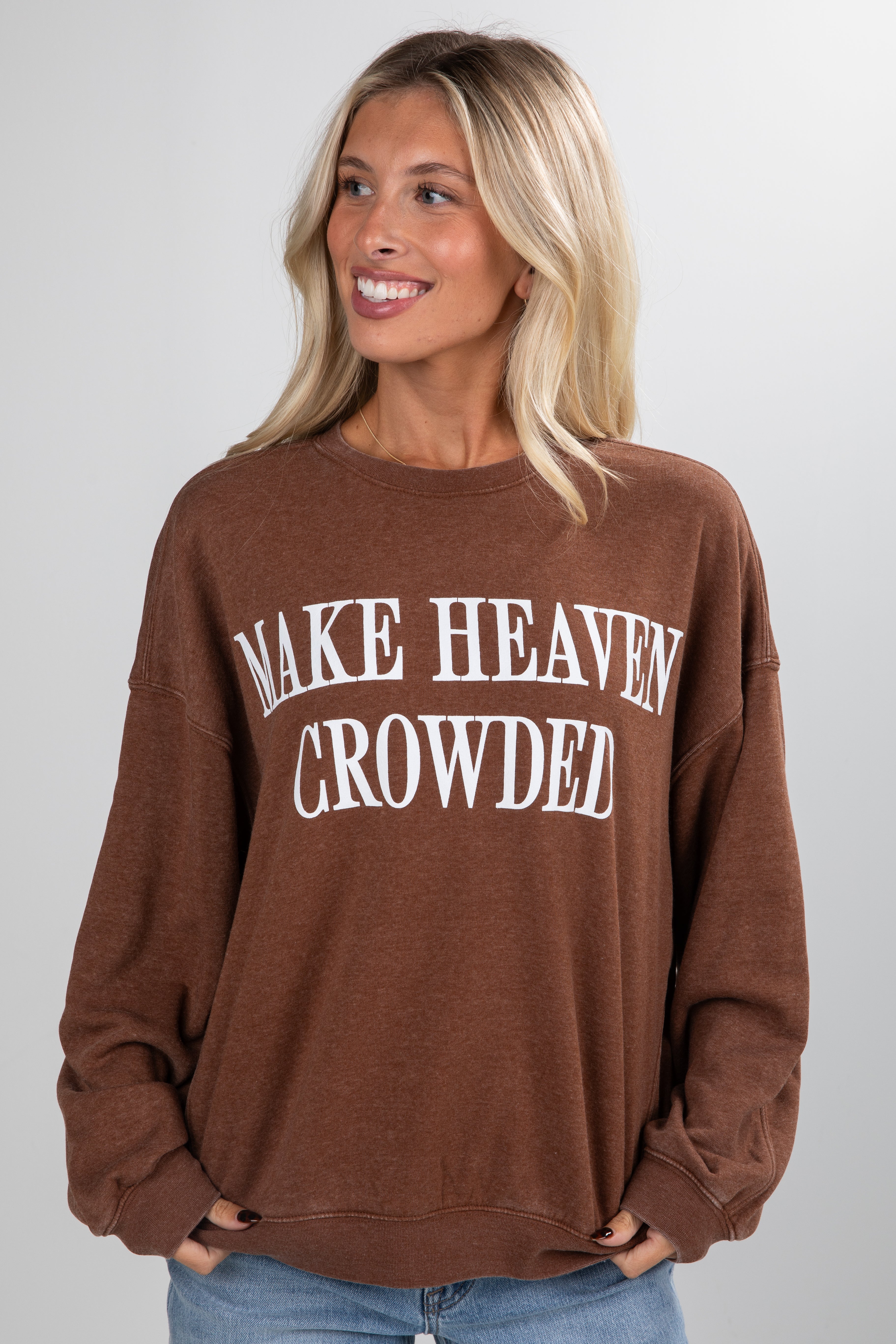 Woman wearing a brown sweatshirt with &