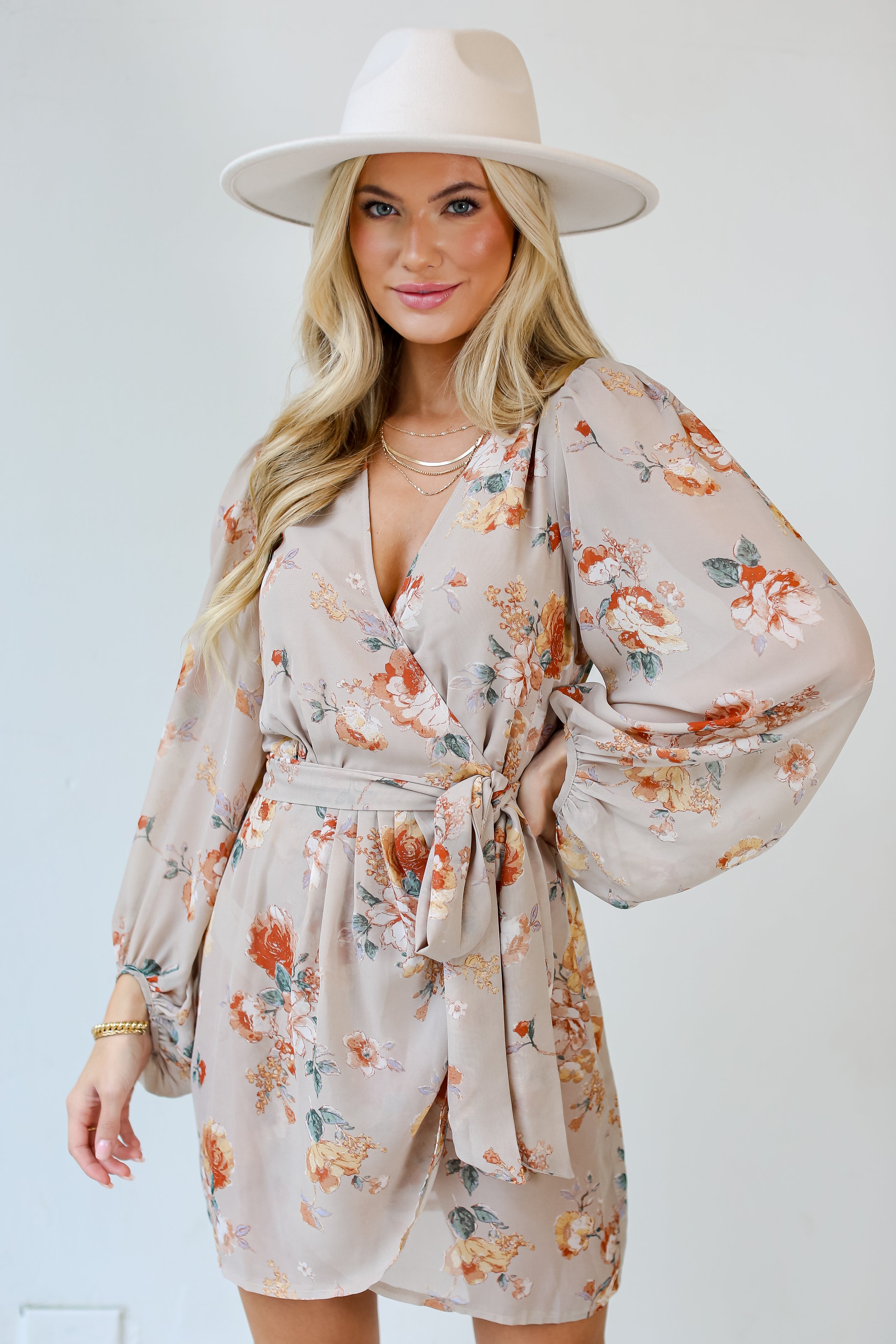model wearing a taupe Floral Wrap Mini Dress 