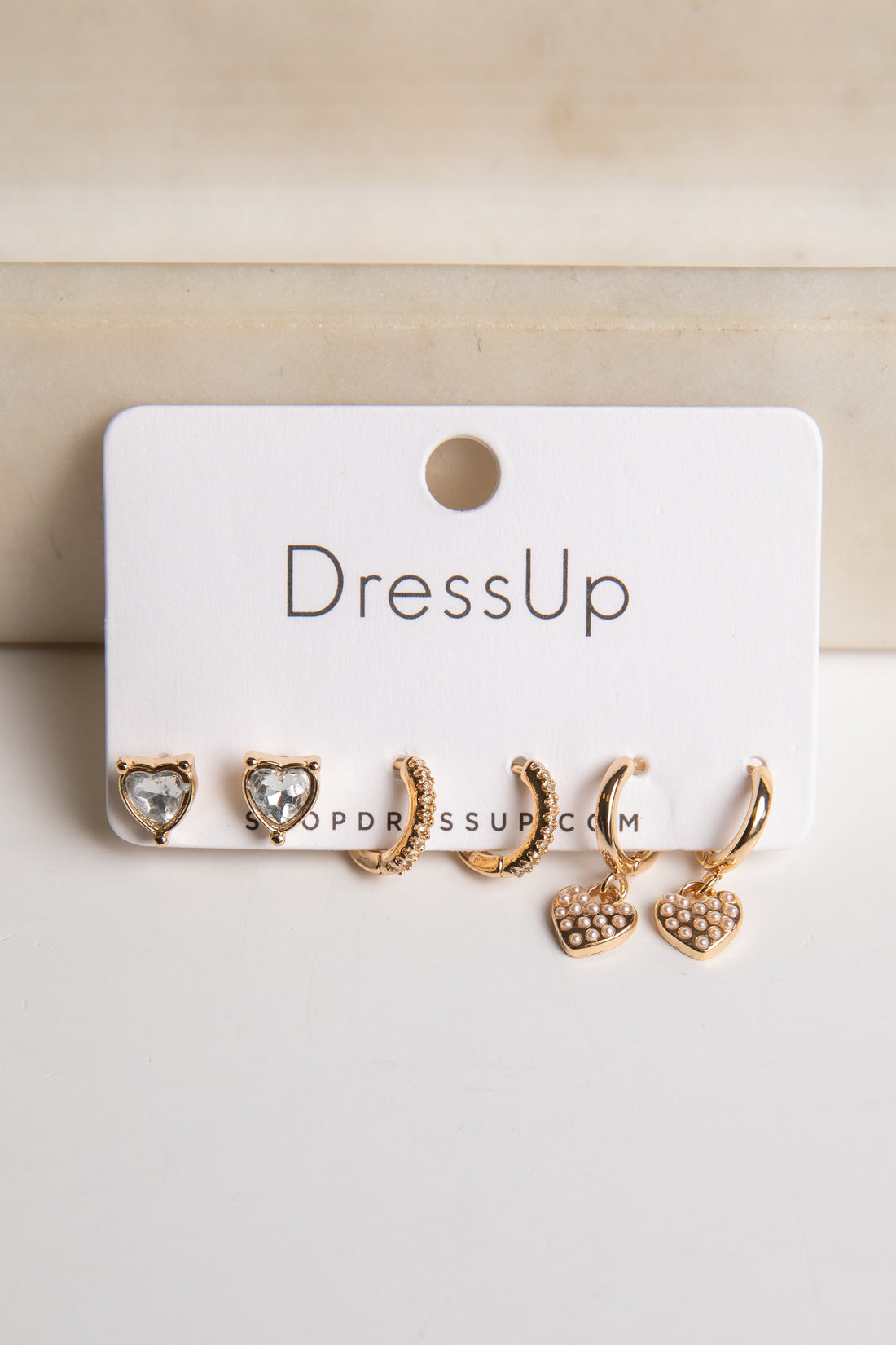 Set of gold earrings on a &