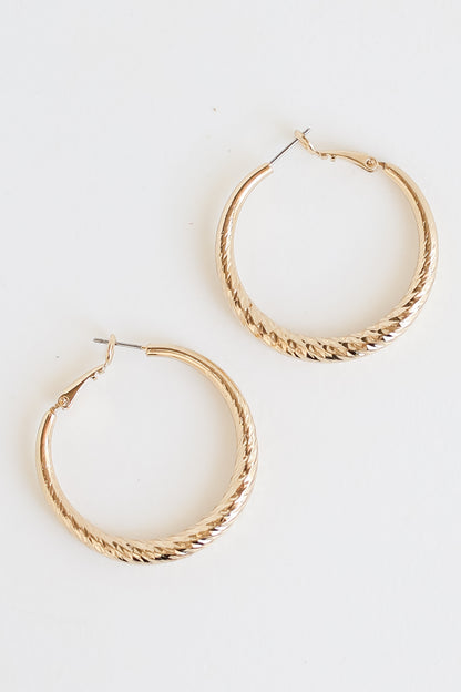 Gold Twisted Hoop Earrings flat lay