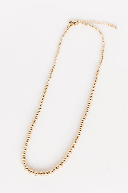 Gold Beaded Necklace flat lay