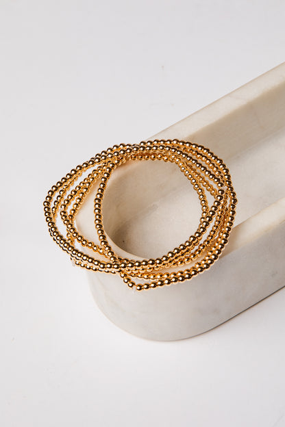set of 5 gold beaded bracelets