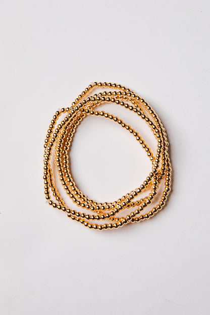 set of 5 gold beaded bracelets