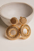 Gold earrings on a light background
