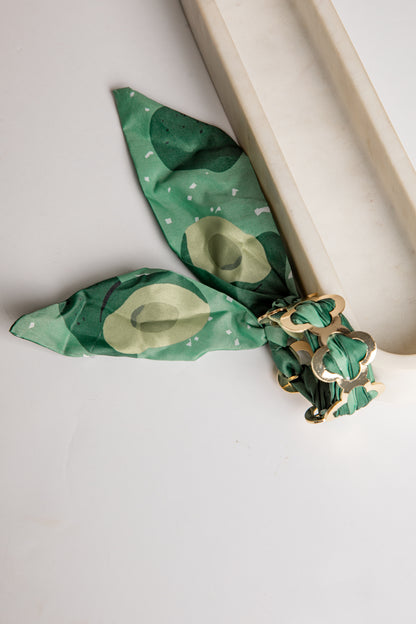 Green bracelet with gold accents on a white background