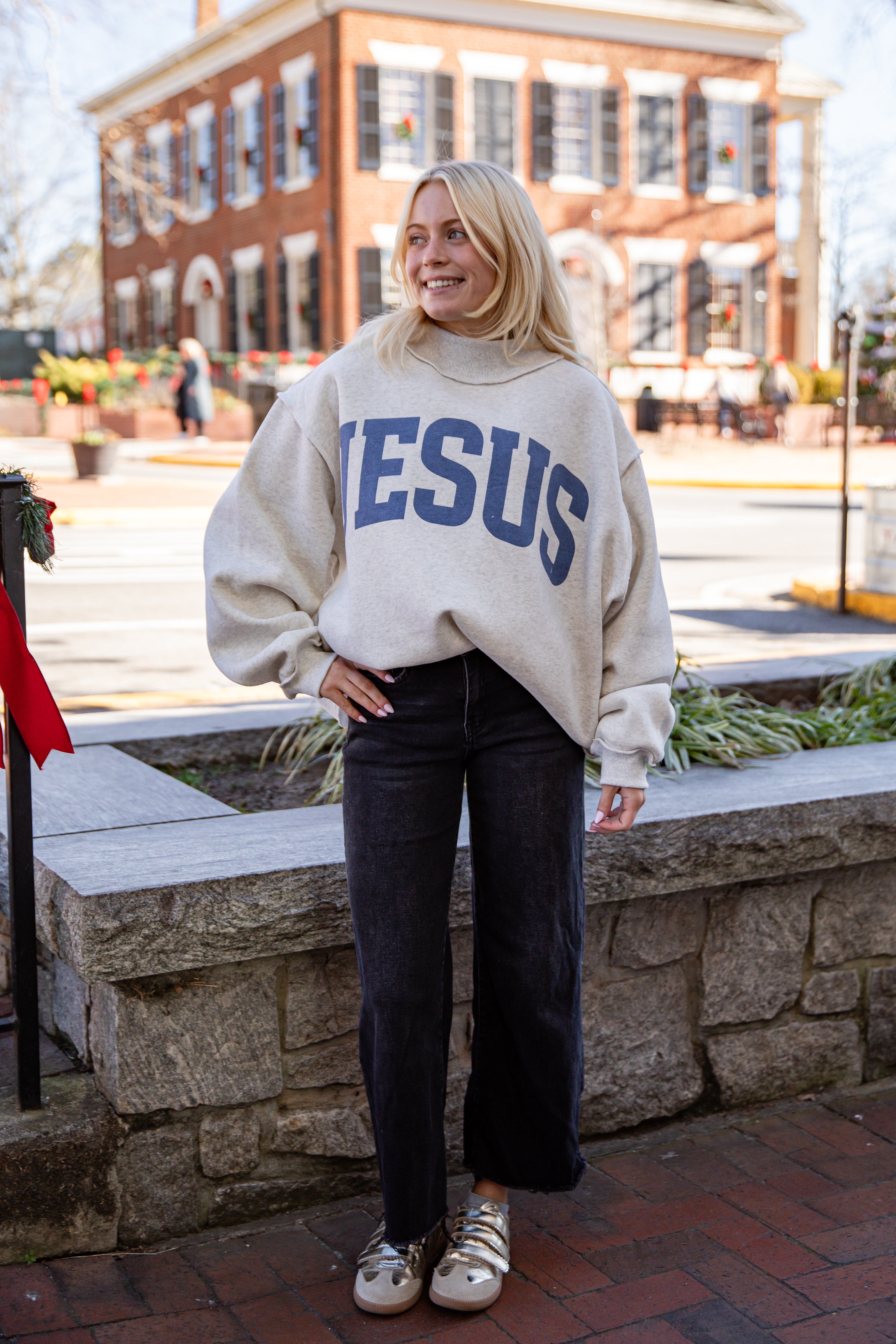 Person wearing a sweater with &