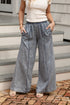 Person wearing wide-leg jeans standing on a set of stairs.