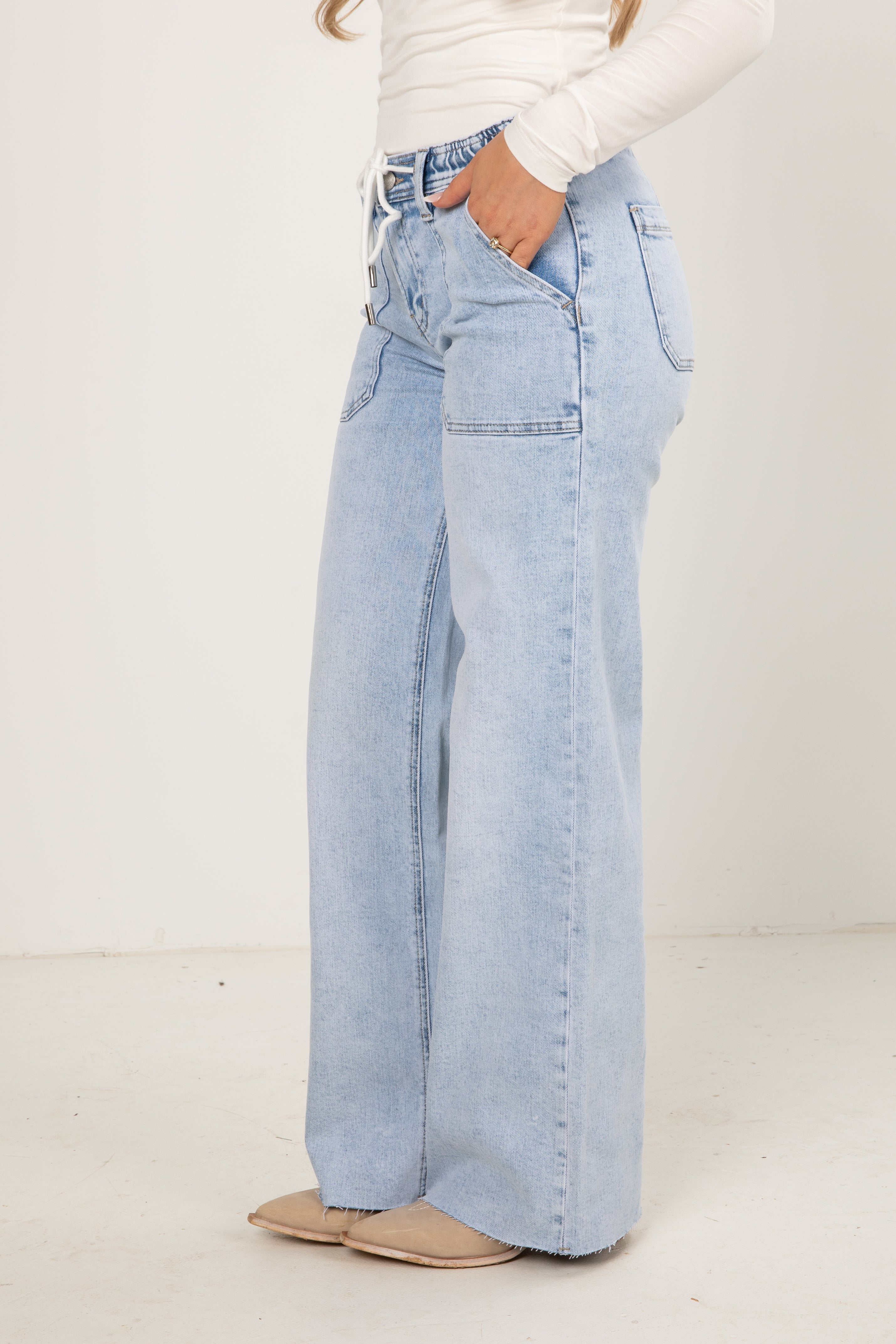 Light blue wide-leg jeans worn by a person on a white background