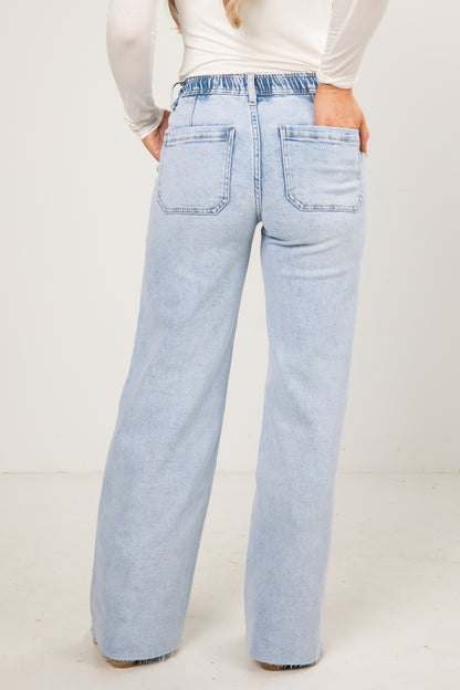 Light blue jeans worn by a person on a white background