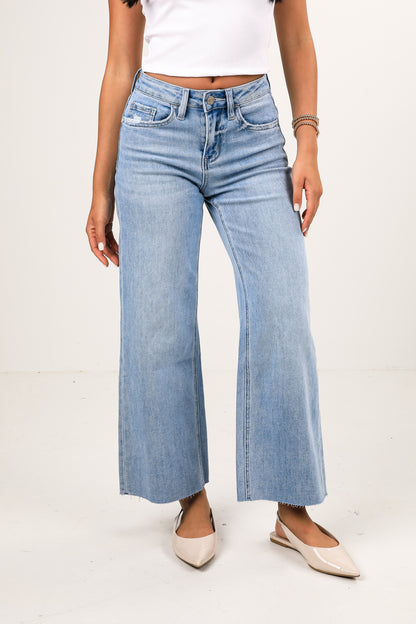 Light blue wide-leg jeans worn by a person on a white background
