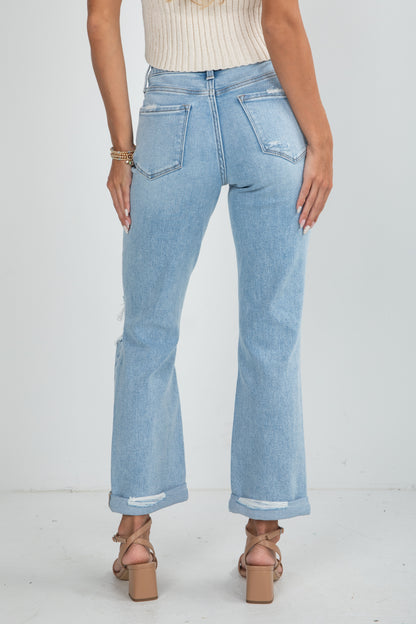 Light blue jeans worn by a person on a white background