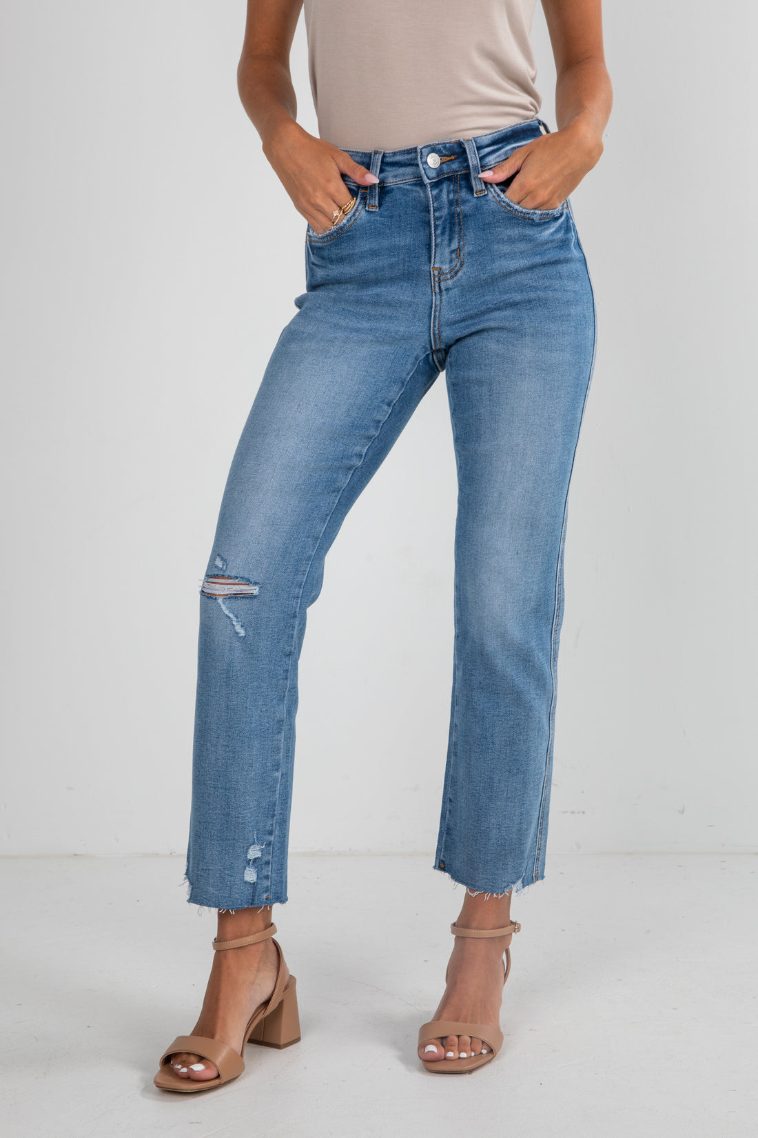 Person wearing blue jeans with a white background