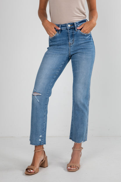 Person wearing blue jeans with a white background