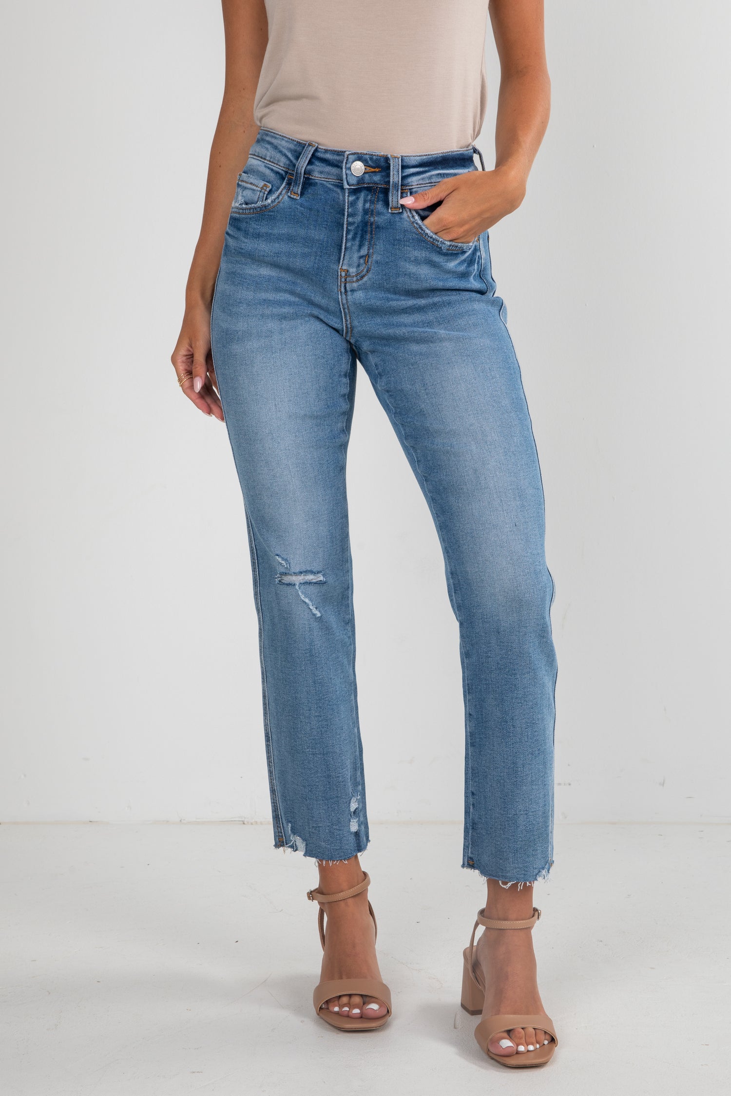 Person wearing blue jeans on a white background
